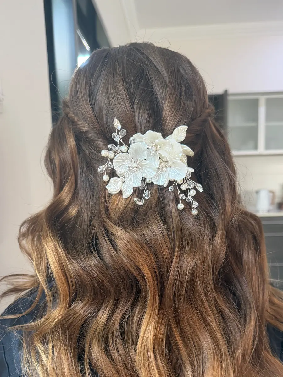 Bridal half-up hairstyle with a mother of pearl floral hairpiece, styled by Kate Bonnie Hair