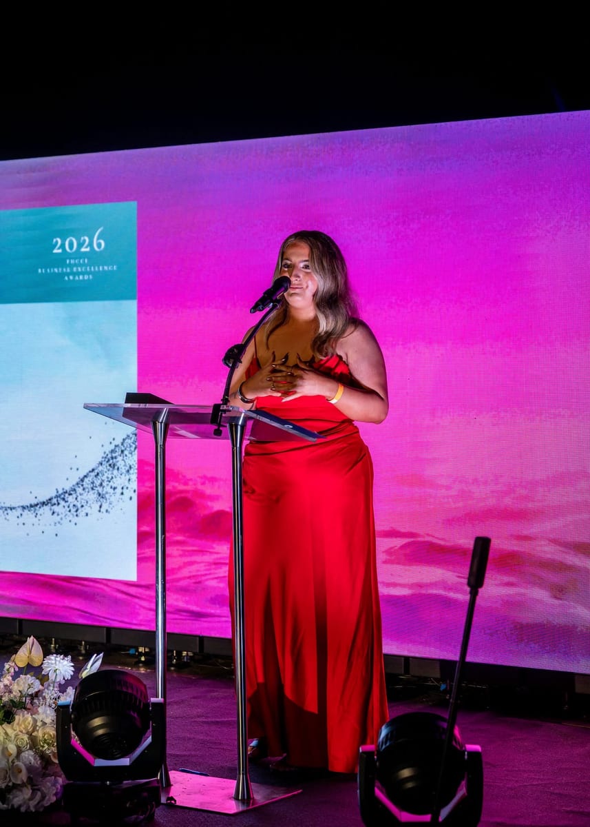 Kate Bonnie accepting the Excellence in Sustainable and Environmental Practice award on stage